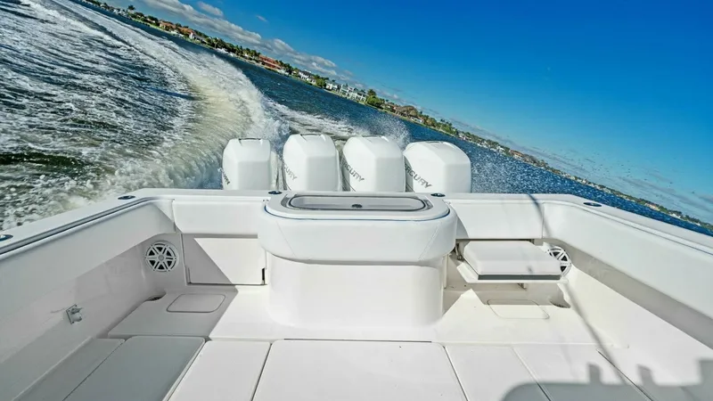 Slide: The Image of Aft Deck with Quad Engines The aft deck of the 2019 Invincible 42 Open Fisherman offers a spacious layout perfect for fishing and leisure. Equipped with powerful quad engines, this vessel ensures a thrilling and smooth ride. The clean, white finish and ample seating provide both co - 7285521