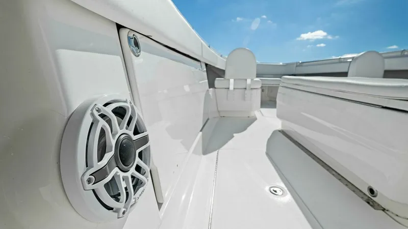 Slide: The Image of Cockpit Seating and Speaker System This image showcases the cockpit area of the 2019 Invincible 42 Open Fisherman, featuring sleek seating with modern styling. The built-in speaker system promises an enhanced audio experience while cruising or fishing. The pristine white finish and spaciou - 7285516