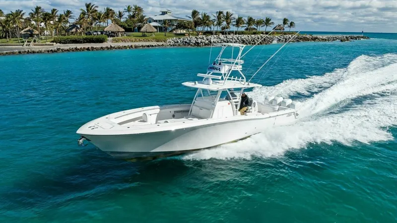 Slide: The Image of Invincible 42 Open Fisherman in Motion The 2019 Invincible 42 Open Fisherman 'Ohana' is captured cruising swiftly over vibrant turquoise waters. Its sleek design is accentuated by a spacious deck layout, perfect for fishing or leisure. The vessel's robust build and modern tower enhance its per - 7285539