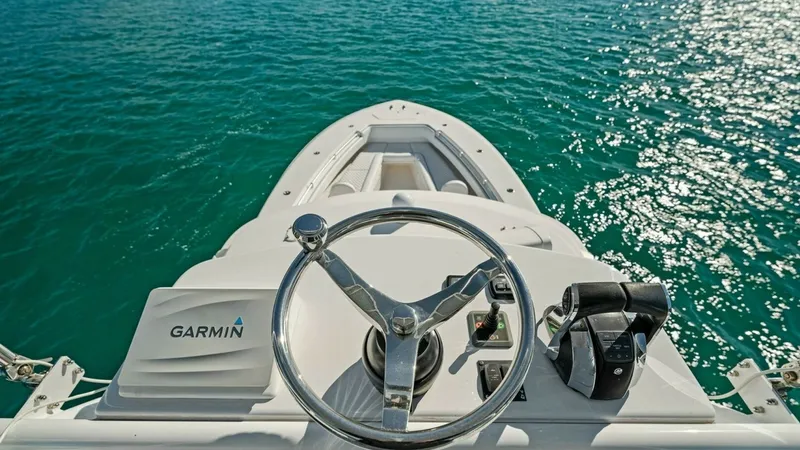 Slide: The Image of Helm Station with Ocean View The helm station of the 2019 Invincible 42 Open Fisherman offers a commanding view of the open ocean. Featuring a sleek Garmin navigation system, polished stainless-steel steering wheel, and ergonomic throttle controls, this area is designed for precision - 7285529