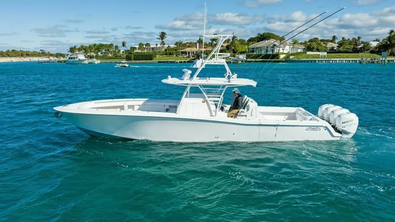 Slide: The Image of Side Profile of Invincible 42 Open Fisherman This image showcases the sleek side profile of the 2019 Invincible 42 Open Fisherman, highlighting its streamlined hull and spacious deck layout. The vessel is equipped with powerful outboard engines for optimal performance on open waters. The boat's desi - 7285536