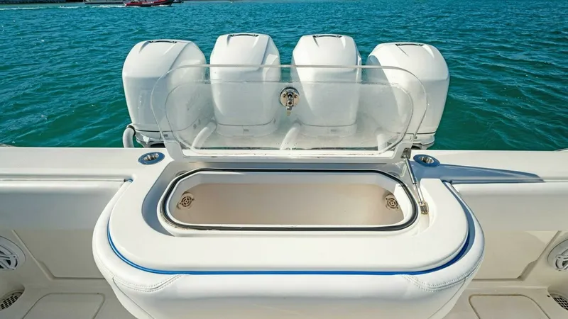 Slide: The Image of Aft Deck Livewell and Engines This image showcases the aft deck of the 2019 Invincible 42 Open Fisherman, featuring a spacious livewell with a clear lid for easy access and monitoring of bait. The sleek design is complemented by the powerful quad engines, offering robust performance f - 7285523