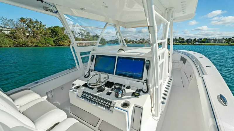 Slide: The Image of Helm Station with Twin Displays The helm station of the 2019 Invincible 42 Open Fisherman features dual high-definition displays for seamless navigation. The ergonomic layout includes a stainless-steel steering wheel and easily accessible controls, ensuring a comfortable and efficient c - 7285509