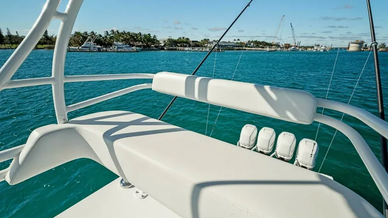 Slide: The Image of Upper Helm Seating Area View This image showcases the upper helm seating area of the 2019 Invincible 42 Open Fisherman, offering a commanding view of the surrounding waters. The cushioned bench provides comfort for those overseeing navigation, while the sleek white finish complements - 7285531