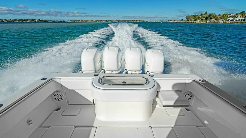 Slide: The Image of Aft Deck with Quad Outboards Experience the power and performance of the Ohana's aft deck, featuring four robust outboard engines that promise an exhilarating ride. The spacious deck offers ample room for fishing or leisure, with a center console for easy access to storage and equipm - 7285505