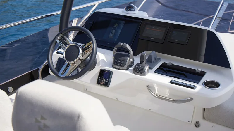 Slide: The Image of Flybridge Helm Station with Electronics The Prestige F5.7's flybridge helm station offers a sleek, modern design with state-of-the-art navigation equipment. The polished steering wheel and intuitive controls provide effortless handling, while the dual digital displays ensure easy access to vita - 7312526