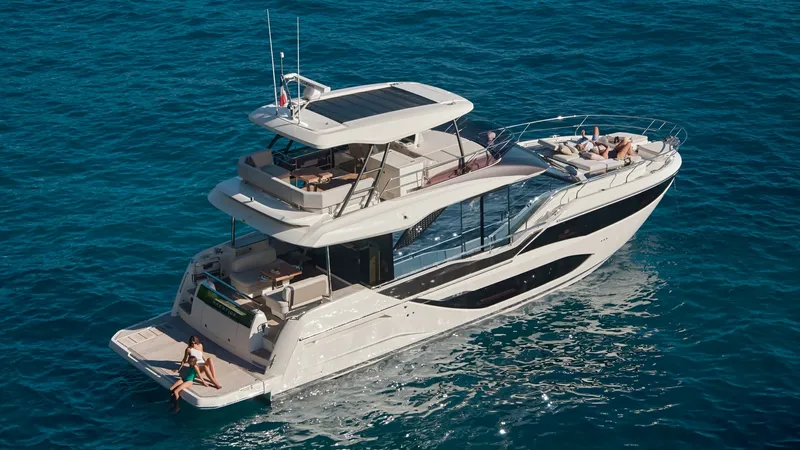 The Image of Aerial View of Flybridge and Aft Deck This aerial shot showcases the expansive flybridge and aft deck of the 2027 Prestige F5.7. The flybridge features ample seating and a sunbathing area, perfect for relaxation and entertaining. The sleek design and modern lines of the vessel are complemente - 7312523