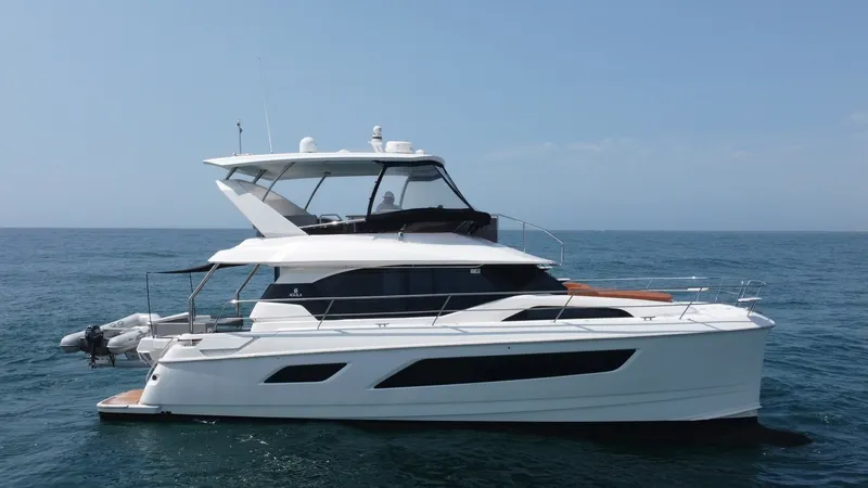 Slide: The Image of Side Profile of Aquila 44 CAT This image showcases the sleek side profile of the 2021 Aquila 44 CAT, emphasizing its modern design and spacious layout. The vessel features expansive windows that provide ample natural light and stunning ocean views. The flybridge offers a well-appointe - 7414042