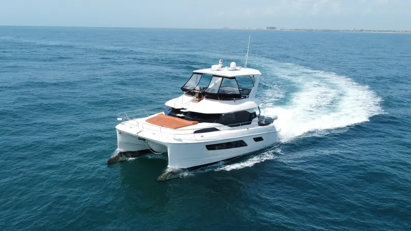 Slide: The Image of Aquila 44 CAT Cruising Bow View The 2021 Aquila 44 CAT is showcased gliding through open waters, highlighting its sleek and modern design. The spacious bow features a comfortable sunpad, perfect for relaxing and enjoying panoramic ocean views. With its dual hull stability, this yacht of - 7414023