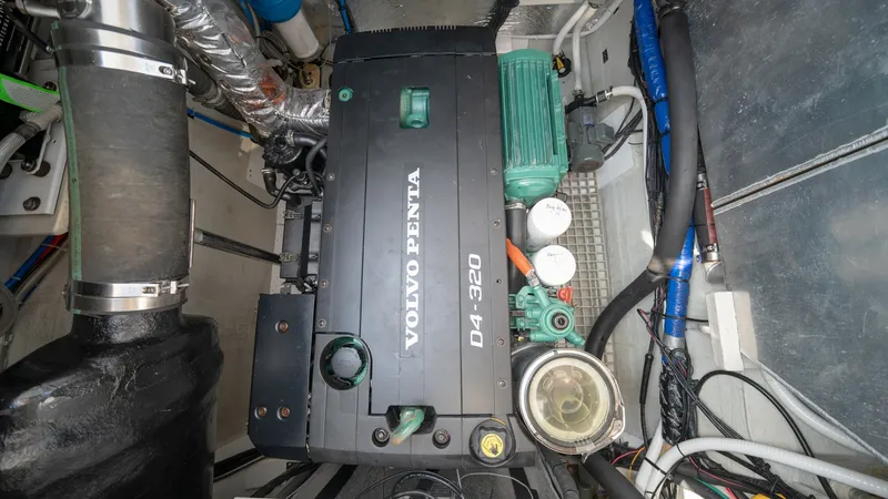 Slide: The Image of Engine Room with Volvo Penta Engine This image showcases the well-organized engine room of the Aquila 44 CAT, featuring a robust Volvo Penta D4-320 engine. The space is efficiently designed, providing easy access to essential components, ensuring optimal maintenance and performance. High-qu - 7413994