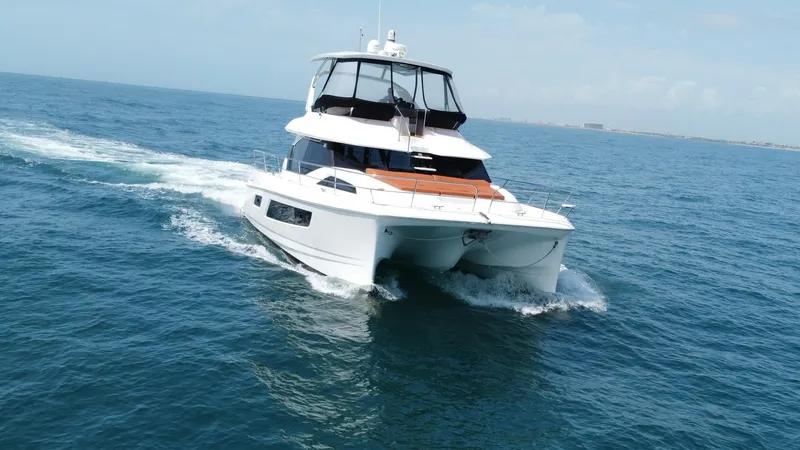 Slide: The Image of Aquila 44 CAT Bow View The Aquila 44 CAT showcases its sleek bow cutting through the waves with elegance. This modern catamaran features a spacious front deck with comfortable seating, ideal for enjoying panoramic ocean views. Its advanced hull design ensures a smooth and stabl - 7414016