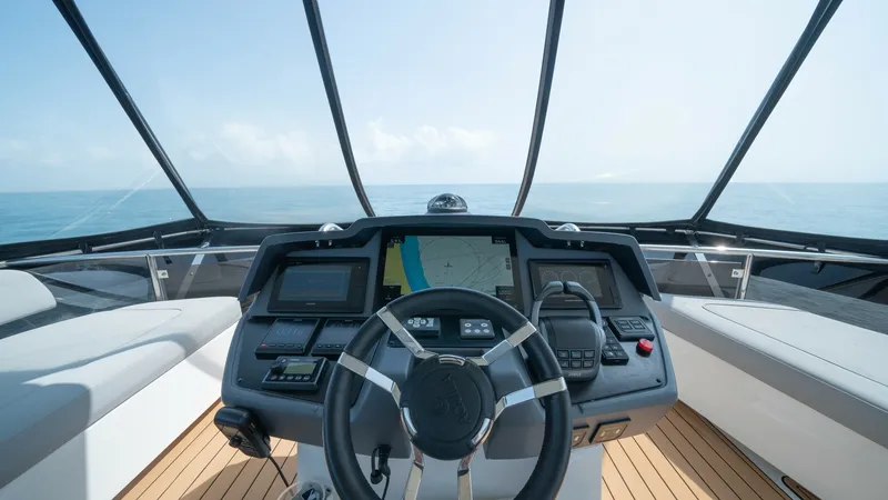 Slide: The Image of Flybridge Helm Station The helm station on the Aquila 44 CAT offers a commanding view of the open sea. Equipped with state-of-the-art navigation systems and a sleek steering wheel, it ensures precise control and ease of use. The surrounding panoramic windows and comfortable sea - 7413990