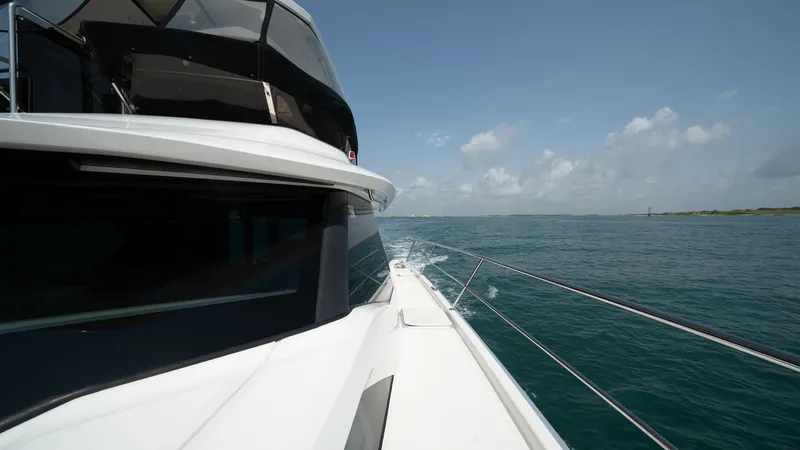 Slide: The Image of Starboard Side Deck and View The starboard side deck of the Aquila 44 CAT offers smooth access with sturdy railings, complemented by expansive ocean views. The sleek design and high-quality finish of the deck enhance both safety and aesthetics, making it ideal for leisurely strolls w - 7414000