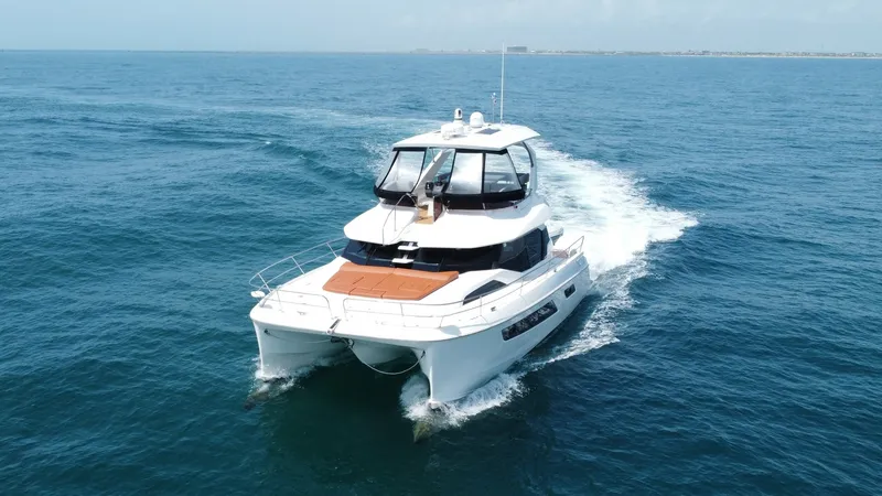 Slide: The Image of Aquila 44 CAT Bow View in Motion The Aquila 44 CAT 'Hey Beautiful' glides effortlessly through the water, showcasing its sleek twin-hull design. The spacious foredeck features a comfortable sunpad, perfect for relaxation while cruising. Large panoramic windows on the bridge offer stunnin - 7414022