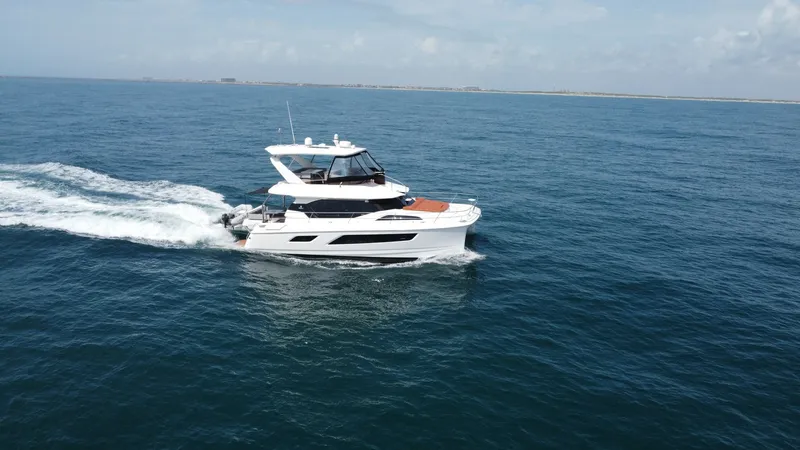 Slide: The Image of Aquila 44 CAT Exterior Running View The 2021 Aquila 44 CAT, 'Hey Beautiful', glides effortlessly across the open sea, showcasing its sleek and modern design. The flybridge provides ample space for relaxation and panoramic views, while the forward sun pad offers a perfect spot for soaking up - 7414010