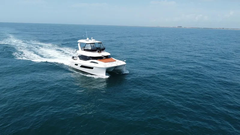 Slide: The Image of Aquila 44 CAT Cruising at Sea The 2021 Aquila 44 CAT, 'Hey Beautiful', is elegantly cruising through open waters, showcasing its sleek design and powerful dual hulls. The flybridge offers panoramic views, while the spacious deck is perfect for lounging in comfort. This vessel combines - 7414014