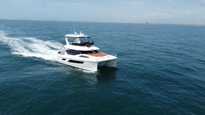 Slide: The Image of Aquila 44 CAT Cruising on Open Water The 2021 Aquila 44 CAT, 'Hey Beautiful,' gracefully glides across the ocean, showcasing its sleek and modern design. The spacious flybridge offers panoramic views, while the vessel's twin hulls ensure stability and a smooth ride. This yacht is perfect for - 7414013
