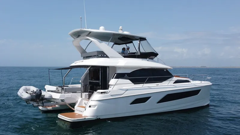 Slide: The Image of Aquila 44 CAT Starboard Exterior View This image showcases the sleek and modern starboard side of the 2021 Aquila 44 CAT, 'Hey Beautiful'. The vessel features a spacious flybridge with a comfortable seating area, perfect for panoramic ocean views. The elegant design is complemented by large w - 7414039