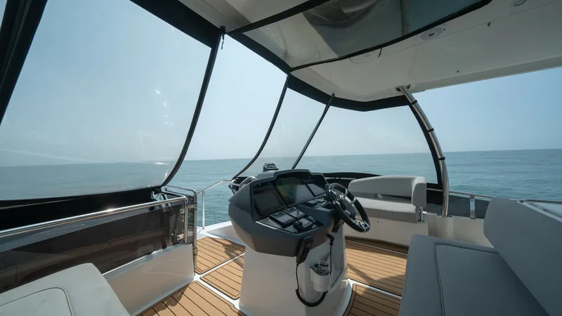Slide: The Image of Flybridge Helm Station with Seating The flybridge of the Aquila 44 CAT offers a commanding helm station equipped with state-of-the-art navigation systems. Surrounded by panoramic views, this area features comfortable wrap-around seating, perfect for relaxing while cruising. The teak floorin - 7413986