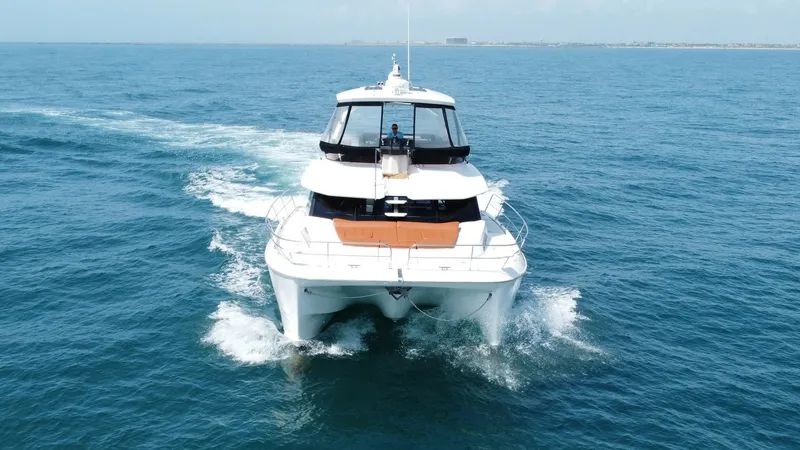 Slide: The Image of Aerial Bow View of Aquila 44 CAT The 2021 Aquila 44 CAT 'Hey Beautiful' showcases a sleek bow cutting through the ocean waters effortlessly. This aerial view highlights the spacious deck area, designed for optimal enjoyment and relaxation. The modern lines and robust build emphasize both - 7414019