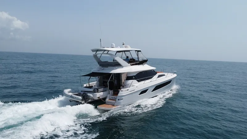 Slide: The Image of Aquila 44 CAT Aft View The Aquila 44 CAT, 'Hey Beautiful', showcases a sleek and modern aft deck with ample space for relaxation. The vessel is equipped with a spacious flybridge and an inviting swim platform, making it ideal for entertaining and enjoying the open sea. With its - 7414028