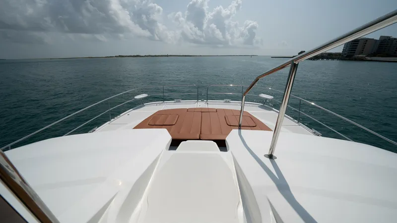 Slide: The Image of Forward Deck with Sunpad Lounge Experience relaxation on the forward deck of the Aquila 44 CAT, featuring a spacious sunpad ideal for lounging while enjoying panoramic ocean views. The sleek design and stainless-steel railing add a touch of elegance and safety, making it perfect for sun - 7413997