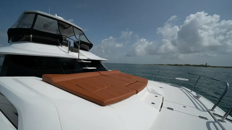 Slide: The Image of Foredeck with Sunpad Lounge The foredeck of the 2021 Aquila 44 CAT features a luxurious sunpad lounge, perfect for relaxation while enjoying the open sea views. The sleek design and durable materials ensure both comfort and style. The surrounding stainless steel safety rails provide - 7413998