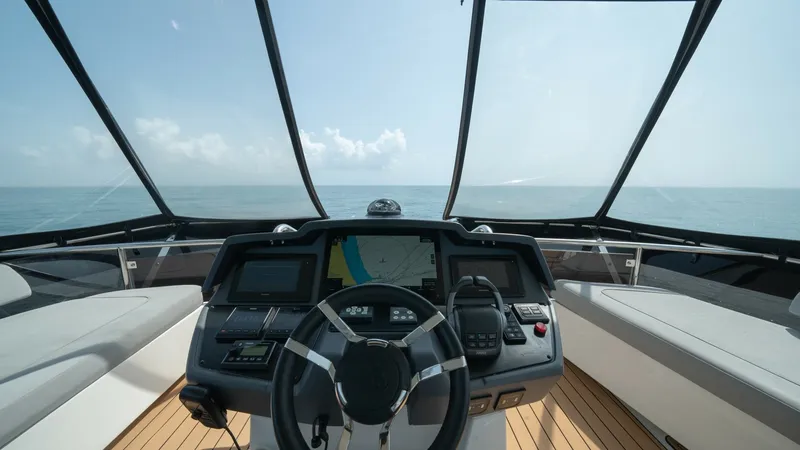 Slide: The Image of Flybridge Helm Station View The flybridge helm station on the 2021 Aquila 44 CAT offers a panoramic view and advanced navigation technology. The helm is equipped with state-of-the-art electronics, including a multifunction display and ergonomic controls, ensuring ease of operation. - 7413987