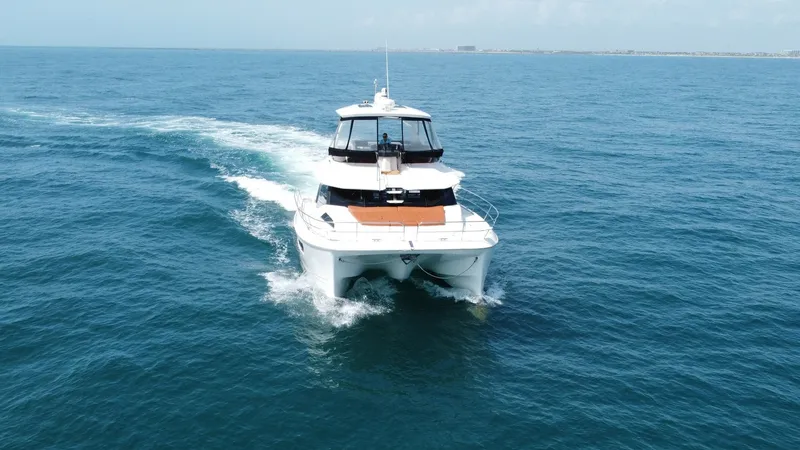 Slide: The Image of Aquila 44 CAT Bow View at Sea The 2021 Aquila 44 CAT, 'Hey Beautiful', gracefully cuts through the ocean waves, showcasing its sleek dual-hull design. The expansive front deck offers ample space for relaxation, enhanced by the yacht's modern lines and efficient, stable cruising capabi - 7414018