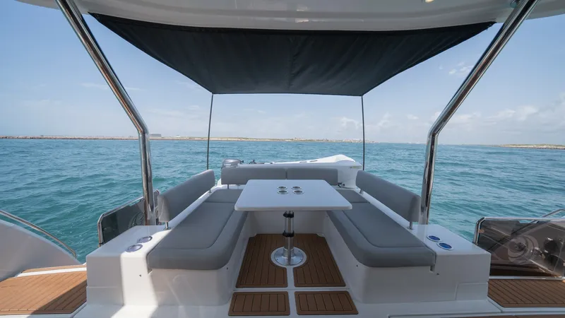 Slide: The Image of Aft Deck Lounge with Sunshade This inviting aft deck on the 2021 Aquila 44 CAT features ample seating with plush cushions, perfect for relaxing or entertaining. The elegant teak flooring adds a touch of luxury, while the retractable sunshade provides comfort and protection from the su - 7413976