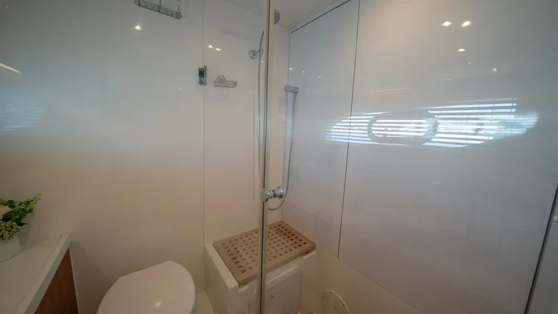Slide: The Image of Modern Ensuite Bathroom The ensuite bathroom on the Aquila 44 CAT features a sleek, modern design with a spacious shower area. The elegant white surfaces and contemporary fixtures create a clean and inviting space. Natural light filters through, enhancing the room's bright and a - 7413960