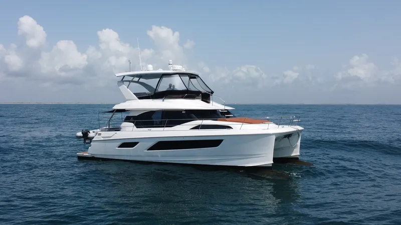 Slide: The Image of Side Profile of Aquila 44 CAT This image showcases the sleek side profile of the 2021 Aquila 44 CAT, 'Hey Beautiful,' gliding effortlessly on the water. The vessel's modern design features expansive windows and a spacious flybridge, emphasizing luxury and panoramic views. Its dual hul - 7414035