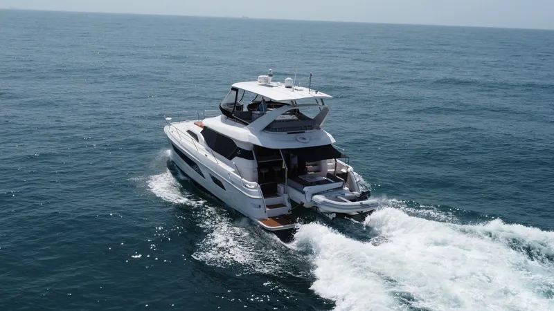 Slide: The Image of Aquila 44 CAT Aft View Underway The Aquila 44 CAT, 'Hey Beautiful', showcases its elegant aft design as it glides through the water. The spacious flybridge and open cockpit offer ample seating and leisure space, perfect for entertaining. This 2021 model features sleek lines and modern f - 7414025