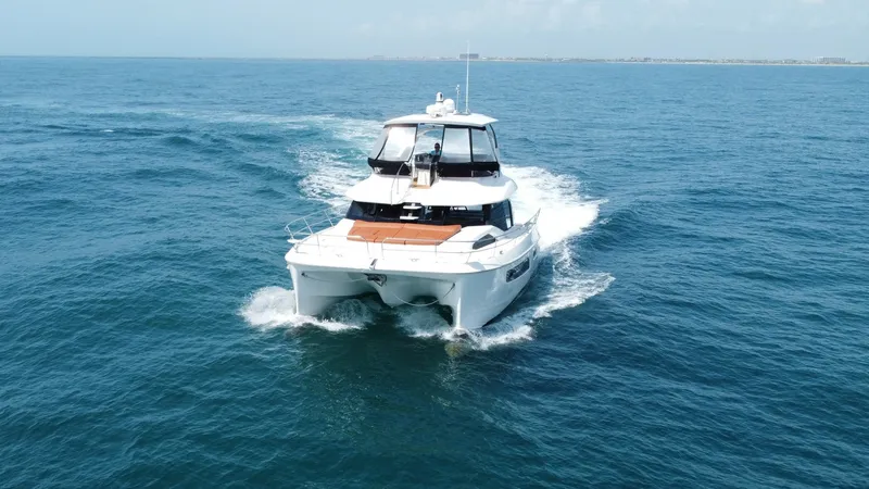Slide: The Image of Aquila 44 CAT Bow View The 2021 Aquila 44 CAT gracefully cuts through the water, showcasing its robust and sleek design. The spacious foredeck is ideal for sunbathing, with ample room for relaxation. Its twin hulls promise stability and smooth sailing, making this catamaran per - 7414021