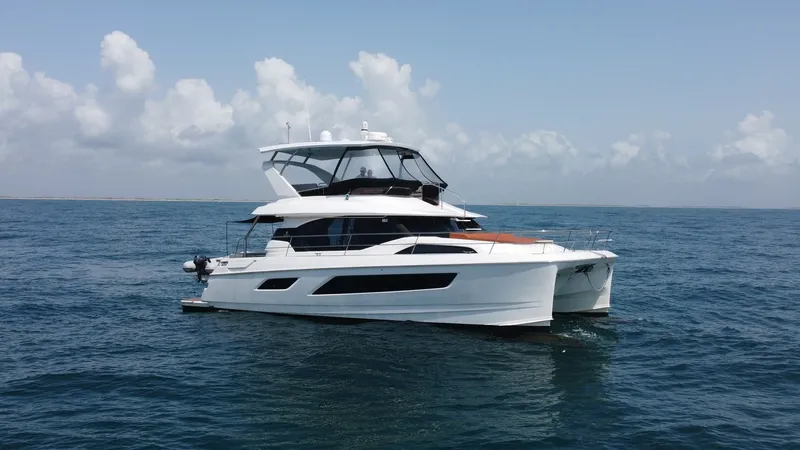Slide: The Image of Aquila 44 CAT Port Side View This image showcases the sleek and modern design of the 2021 Aquila 44 CAT, highlighting its spacious flybridge and elegant lines. The vessel's catamaran hull offers stability and a smooth ride, while the expansive windows provide panoramic views. Ideal f - 7414034