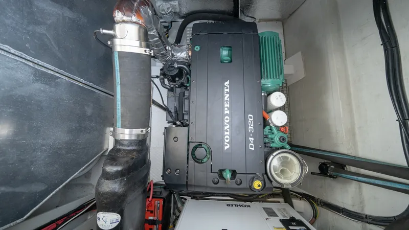 Slide: The Image of Engine Room with Volvo Penta Engine This image showcases the engine room of the 2021 Aquila 44 CAT, featuring a powerful Volvo Penta D4-320 engine. The well-organized space highlights robust engineering and easy access for maintenance, ensuring reliable performance. The room's clean layout - 7413993