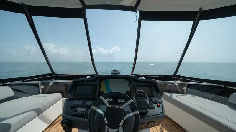 Slide: The Image of Helm Station with Panoramic View The helm station of the 2021 Aquila 44 CAT offers a commanding panoramic view through its expansive windows. The modern dashboard is equipped with state-of-the-art navigation systems, ensuring a seamless sailing experience. Plush seating on either side pr - 7413988