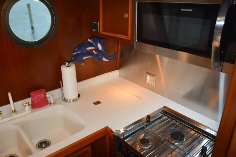 Slide: The Image of Custom Galley With Lolded Countertop Sink And Stainless Appliances And Splash Panels - 7509687