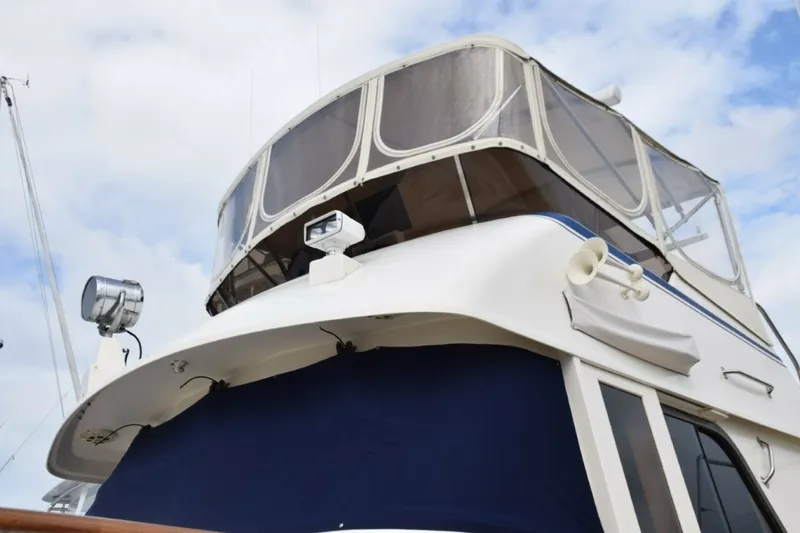Slide: The Image of Navy Sunbrella Canvas Windshield Mask, Name Board Covers, And 3 Sided Flybridge Enclosure With U Zips - 7509675