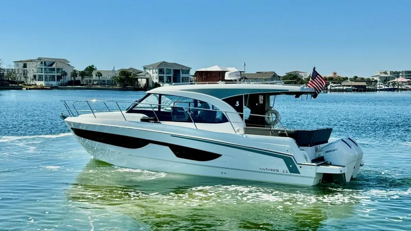 Slide: The Image of Starboard View of Beneteau Antares 11 The 2022 Beneteau Antares 11 glides gracefully through the water, showcasing its sleek starboard profile. This modern vessel features a spacious cockpit with ample seating, perfect for socializing or relaxing. Its elegant design is complemented by a hardt - 7403701