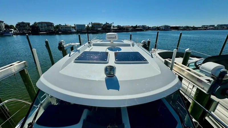 Slide: The Image of Flybridge Roof with Solar Panels This image showcases the sleek flybridge roof of the 2022 Beneteau Antares 11, equipped with integrated solar panels. The aerodynamic design enhances both fuel efficiency and style, while the solar panels provide an eco-friendly energy source for onboard - 7403690