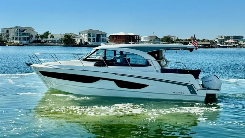 Slide: The Image of Starboard Profile of Beneteau Antares 11 This image showcases the sleek starboard side of the 2022 Beneteau Antares 11, highlighting its modern design and spacious layout. The vessel features a streamlined hull with elegant lines and large windows for ample natural light. The open flybridge and - 7403700