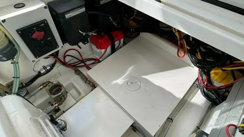 Slide: The Image of Engine Compartment Overview This image showcases the well-organized engine compartment of the 2022 Beneteau Antares 11. Visible are the neatly arranged wiring and battery systems, highlighting the vessel's efficient electrical layout. The compartment is designed for easy access and - 7403689