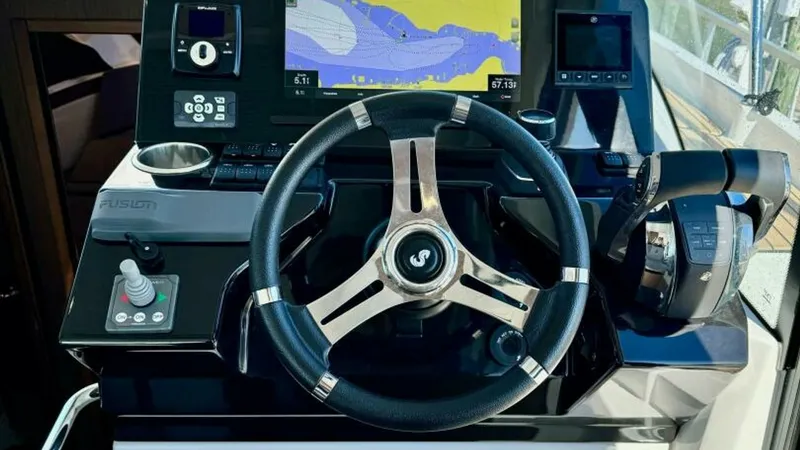 Slide: The Image of Helm Station with Navigation Display The helm station of the 2022 Beneteau Antares 11 features a sophisticated navigation setup, complete with a large display screen for easy chart viewing. The sleek, modern steering wheel is complemented by intuitive controls, ensuring a seamless boating ex - 7403678
