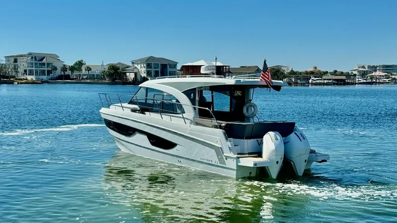 Slide: The Image of Aft View with Twin Outboard Engines This image showcases the sleek aft design of the 2022 Beneteau Antares 11, prominently featuring twin outboard engines for powerful performance. The spacious aft deck includes comfortable seating, ideal for socializing and enjoying the open water. The ves - 7403702