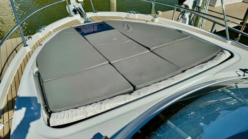 Slide: The Image of Spacious Foredeck Sunpad Area The foredeck of the 2022 Beneteau Antares 11 features a luxurious sunpad, perfect for relaxation and sunbathing. The ample cushioned space provides comfort and style, enhanced by the sleek design lines of the vessel. Surrounded by secure railings, this ar - 7403695