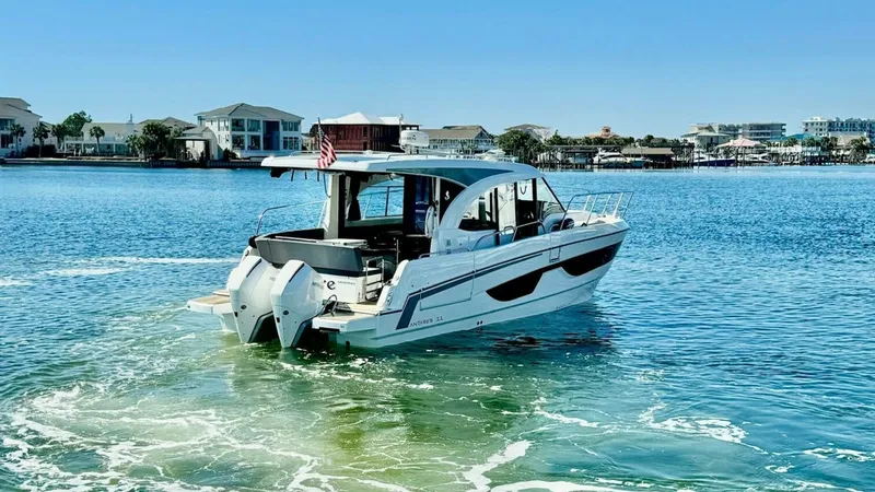 Slide: The Image of Aft View with Dual Outboards This image showcases the aft view of the 2022 Beneteau Antares 11, highlighting its sleek design and powerful dual outboard engines. The spacious cockpit area is perfect for socializing or relaxing, featuring comfortable seating and easy access to the swi - 7403703