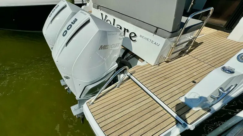 Slide: The Image of Aft Deck with Twin Outboards This image showcases the aft deck of the 2022 Beneteau Antares 11, featuring twin 300 horsepower Mercury outboard engines. The deck is elegantly finished with teak flooring, providing both durability and a touch of luxury. The area offers convenient acces - 7403693