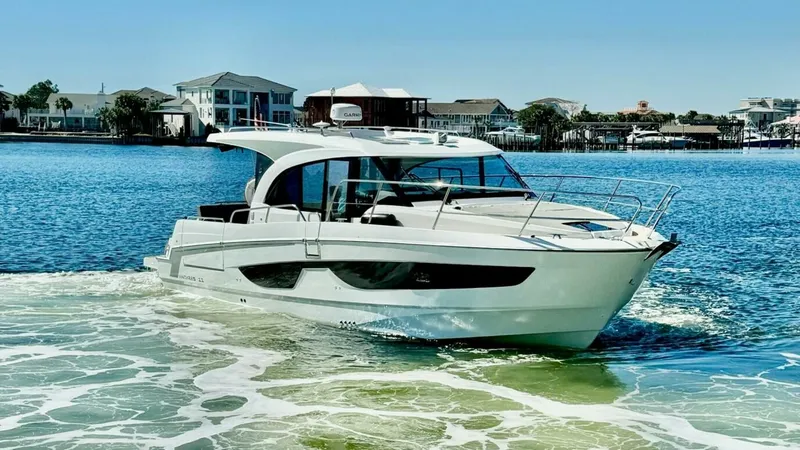 Slide: The Image of Starboard Side View in Motion The 2022 Beneteau Antares 11 glides smoothly across the water, showcasing its sleek and modern design. The starboard side highlights the spacious cabin with large windows, providing ample natural light and stunning views. This vessel's streamlined hull an - 7403697
