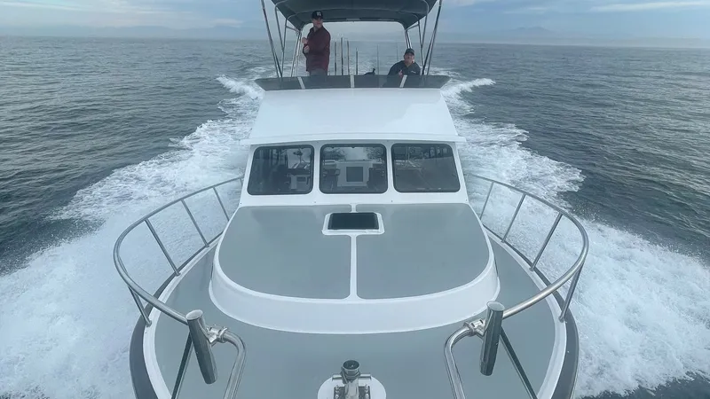 Slide: The Image of Flybridge and Bow View This image showcases the sleek design of the 2019 Donelle 36 Flybridge Sportfish from the bow perspective. The spacious flybridge is visible, offering commanding views and ample space for navigation. The elegant bow features sturdy railings and a clean de - 7398008